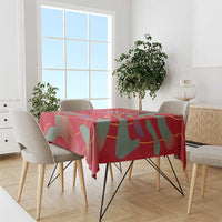 Red football tablecloth with abstract shapes draped over dining table and chairs