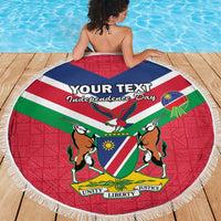Round Namibia beach blanket with coat of arms graphic and fringe border