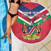 Round beach blanket showing Namibia independence crest with fringe border