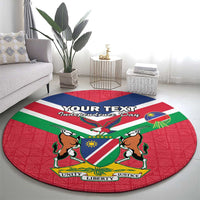 Red round rug with Namibia emblem, flag colors, and Unity Liberty Justice labels