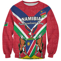 Red crewneck sweatshirt with Namibia Independence Day text and coat of arms graphic
