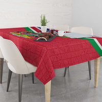 Red Namibia flag-themed tablecloth draped over dining table with coat of arms
