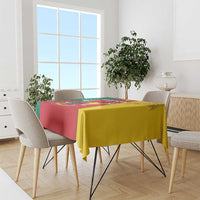 Cameroon flag tablecloth draped over dining table, red yellow green with coat of arms