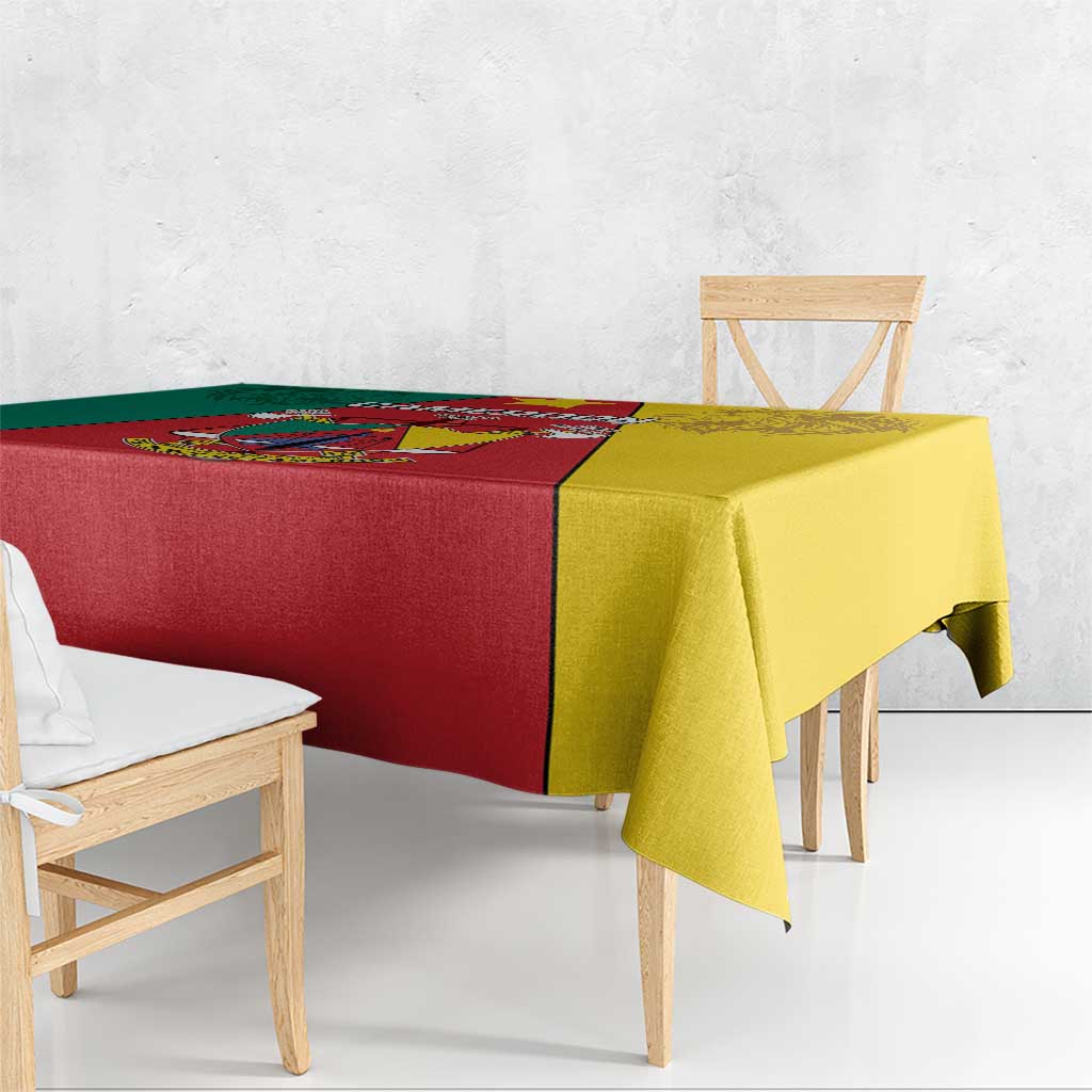 Cameroon flag tablecloth on bench table, red center with yellow and green sections