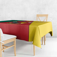 Cameroon flag tablecloth on bench table, red center with yellow and green sections
