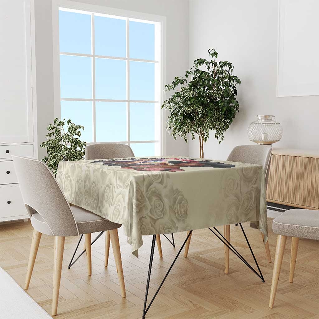 Cream rose-pattern tablecloth with colorful derby artwork on the front