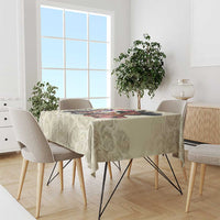 Cream rose-pattern tablecloth with colorful derby artwork on the front