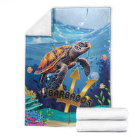 Blue sea turtle blanket with underwater artwork and gold emblem, with folded white towels