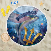 Round blue beach blanket with flying fish print and white fringe, displayed on sand