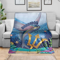 Blue flying fish blanket draped on a gray sofa, gold crest over ocean scene