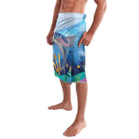 Blue ocean-themed knee-length beach shorts with wave and flying fish graphic