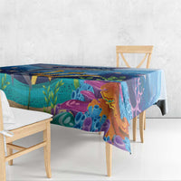 Square ocean tablecloth draped on a table with colorful underwater fish and coral patterns