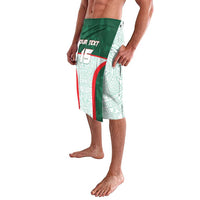Side view of green and aqua Aztec-pattern shorts with elastic waist and curved panel