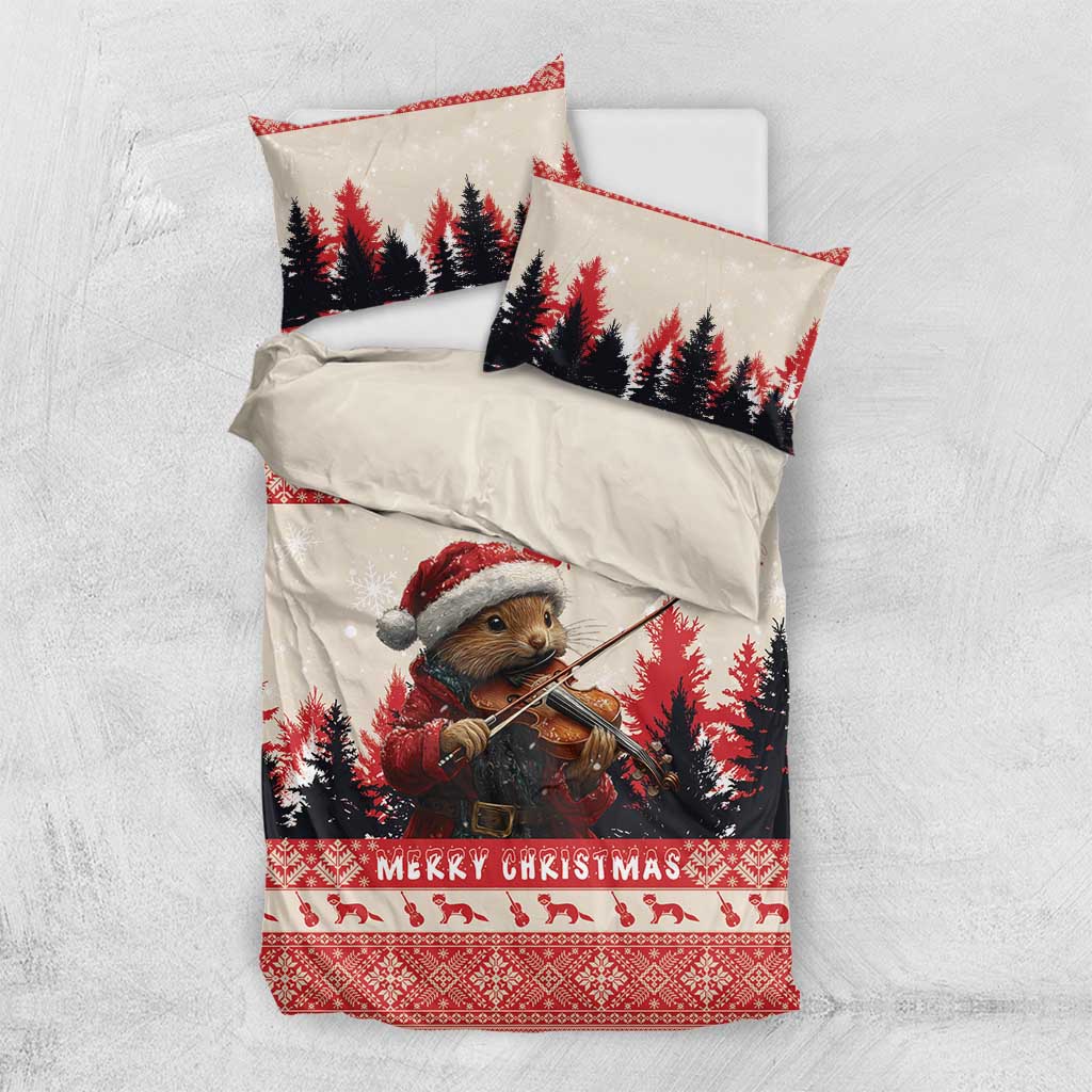 Christmas bedding set shown laid flat: quilt with pine marten violin scene and matching pillows