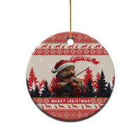 Round red-and-white ceramic Christmas ornament with pine marten playing violin, hanging by gold cord