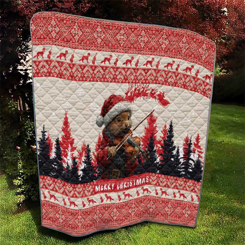 Red Christmas quilt with pine marten playing violin and pine trees, bordered with 'Merry Christmas'.