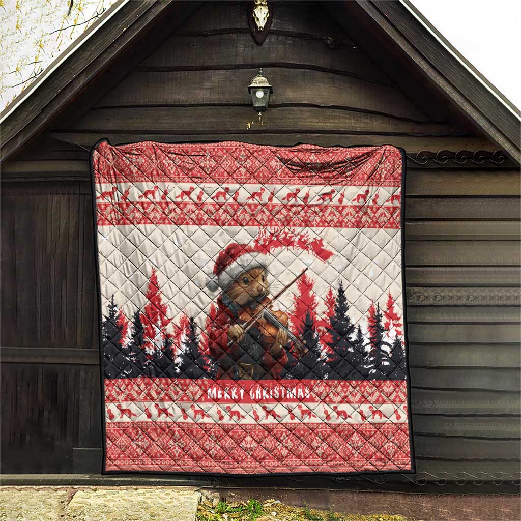Red Christmas quilt hung on a wooden wall, featuring pine marten playing violin and pine trees.