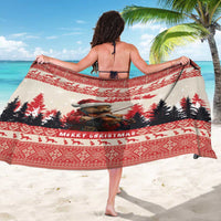 Red and cream Christmas sarong featuring violin-playing marten and pine tree border