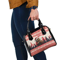 Red and black Christmas handbag with black handles, zipper top, and crossbody strap