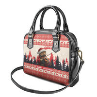 Red and black Christmas handbag with glossy black trim, two handles, and long shoulder strap