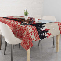 Red and black Christmas tablecloth with pine tree silhouette and snowy motif