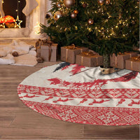 Round Christmas tree skirt with red and white holiday silhouettes pattern