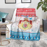 Christmas blanket with coat of arms crest, blue pine scene along bottom edge