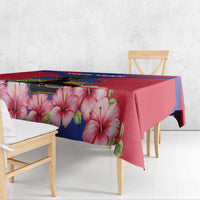 Haiti independence tablecloth draped over bench with pink hibiscus and red-blue flag print