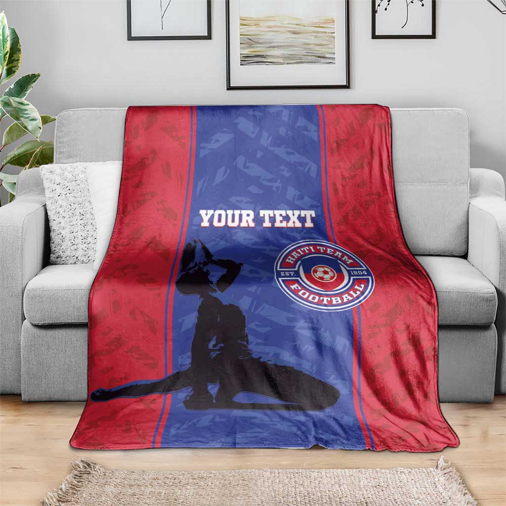 Red and blue football blanket with custom text and Haiti football crest, laid on couch
