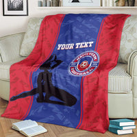 Red and blue football blanket showing custom text and Haiti team emblem, on loveseat