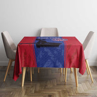 Custom football tablecloth on dining table with red and blue center, crest logo and silhouette.