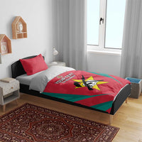 Red and teal Os Mambas bedding set on bed with star emblem and two red pillowcases