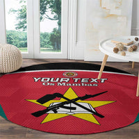 Red round area rug with green border and football crest, custom text banner.