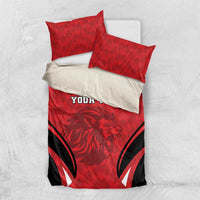 Red football bedding set with lion emblem, black stripes, and two coordinated pillowcases