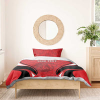 Red football bedding set with lion emblem, black swoop stripes, and two pillowcases