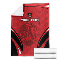 Folded red and black football blanket with lion crest and 'YOUR TEXT' print, white towels