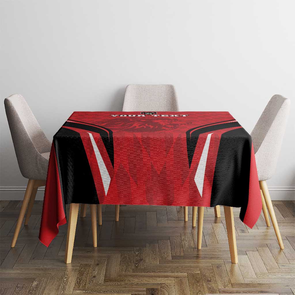 Red and black football tablecloth draped over square table with white chair backs