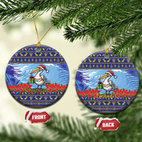 Ceramic Christmas ornament, round blue pelican with poinsettias; “Merry Christmas” and “Barbados”