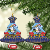 Ceramic Christmas ornament, tree-shaped blue pelican with poinsettias; “Merry Christmas” and “Barbados”