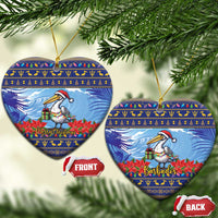 Ceramic Christmas ornament set, round blue pelican with poinsettias; front shows “Merry Christmas”