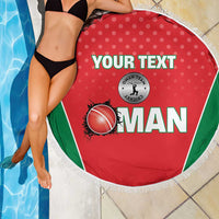 Red round beach blanket with green edge panels and white fringe, placed poolside
