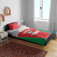 Red and green cricket-themed bedding set on a bed with two matching pillowcases.