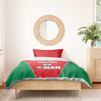 Red and green cricket-themed bedding set with duvet and pillow on wooden bed frame.