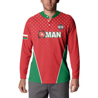 Red cricket button sweatshirt with green collar and Oman logo, worn by model