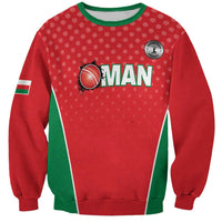 Red cricket sweatshirt with green diagonal stripe and 'OMAN' front graphic