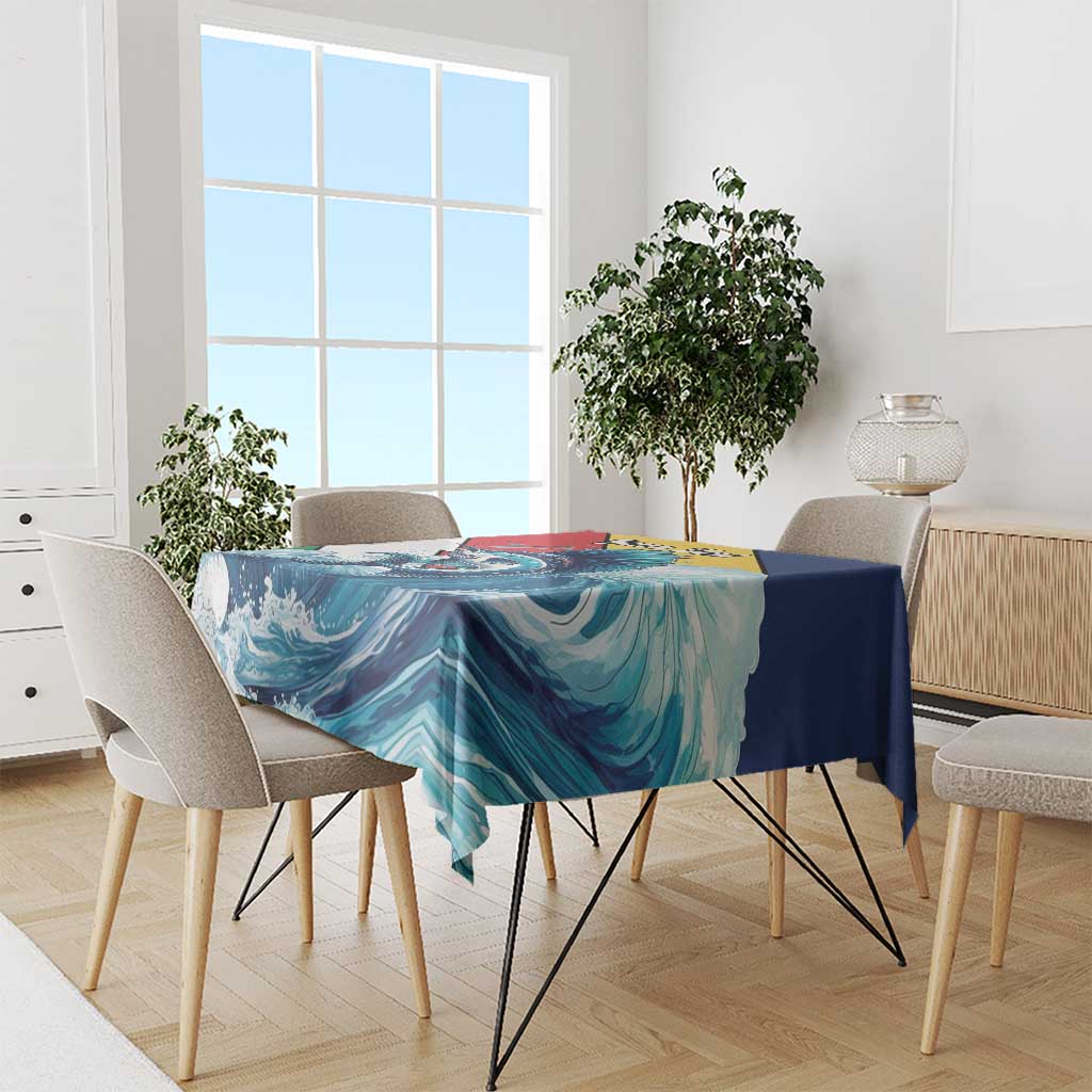 Tablecloth draped over dining table with teal, blue wave pattern and sailfish artwork