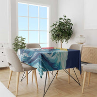 Tablecloth draped over dining table with teal, blue wave pattern and sailfish artwork