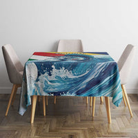Square tablecloth on dining table with teal-blue wave and sailfish scene, red accent band