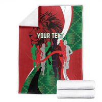 Personalized athletics Kenya blanket, red and green runners with 'YOUR TEXT' and folded stack.