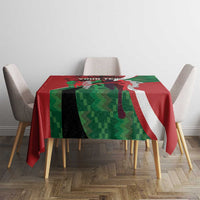 Red, green and white athletics tablecloth on small round table with four chairs